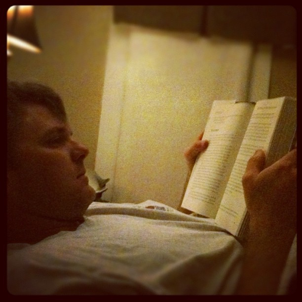 In bed, reading with hubs.