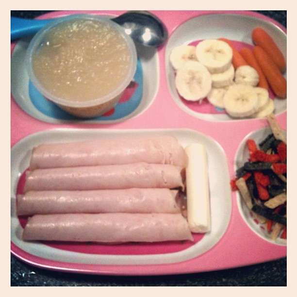 What dinner looks like tonight for two picky girls. #applesauce #banana #carrots #turkeyrollups #stringcheese #tortillastrips